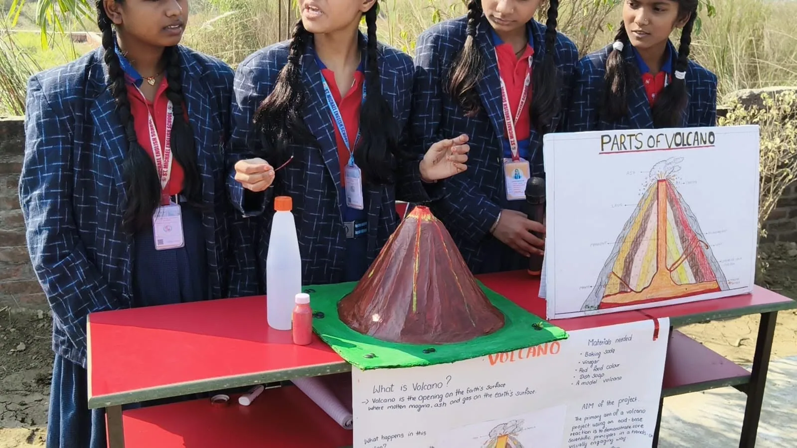 A student-built volcano model displayed with written notes at the science exhibition
