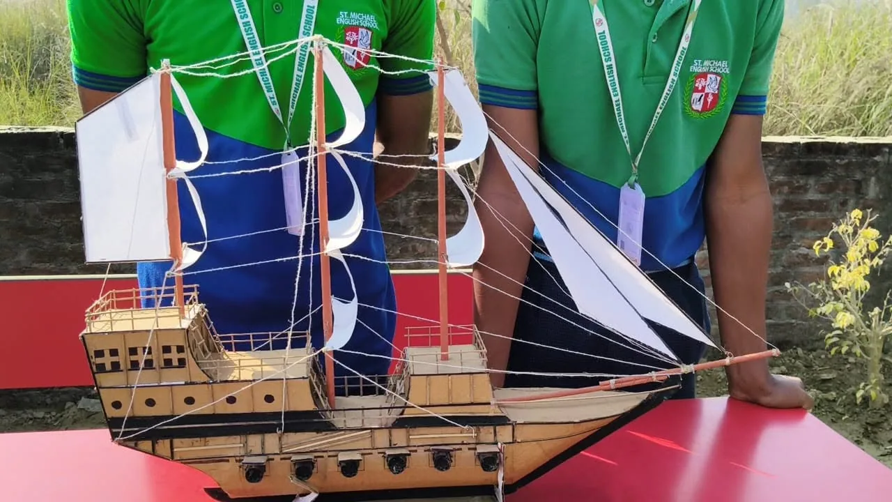 A detailed hand-built model sailing ship made by students, displayed at the exhibition