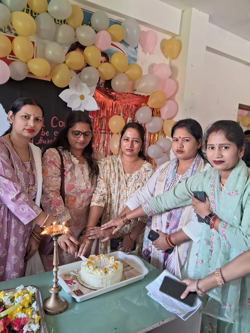 Guests lighting a ceremonial lamp at a school event